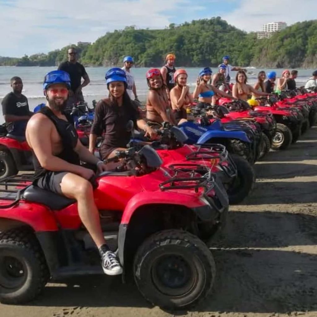 a group of people on four wheelers