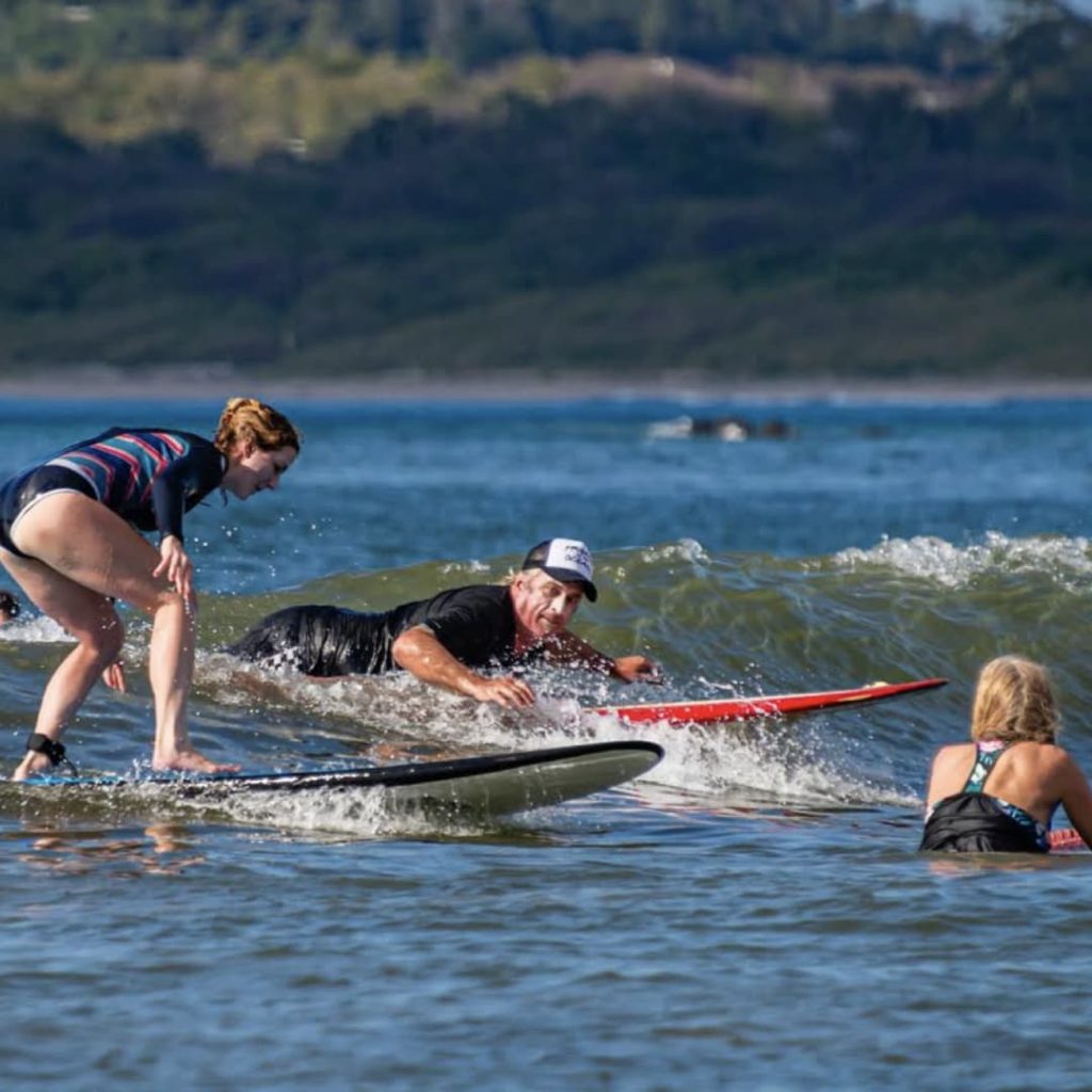 a group of people surfing in the water
