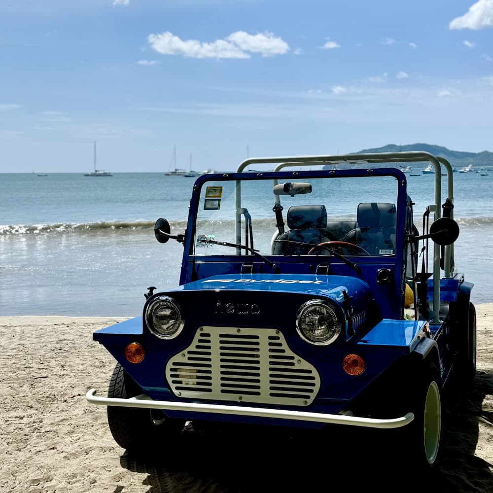 A blue vehicle in the beach