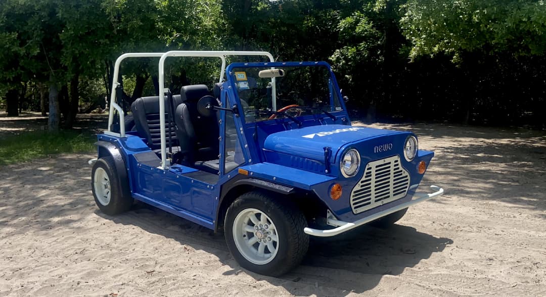 A blue car on the beach