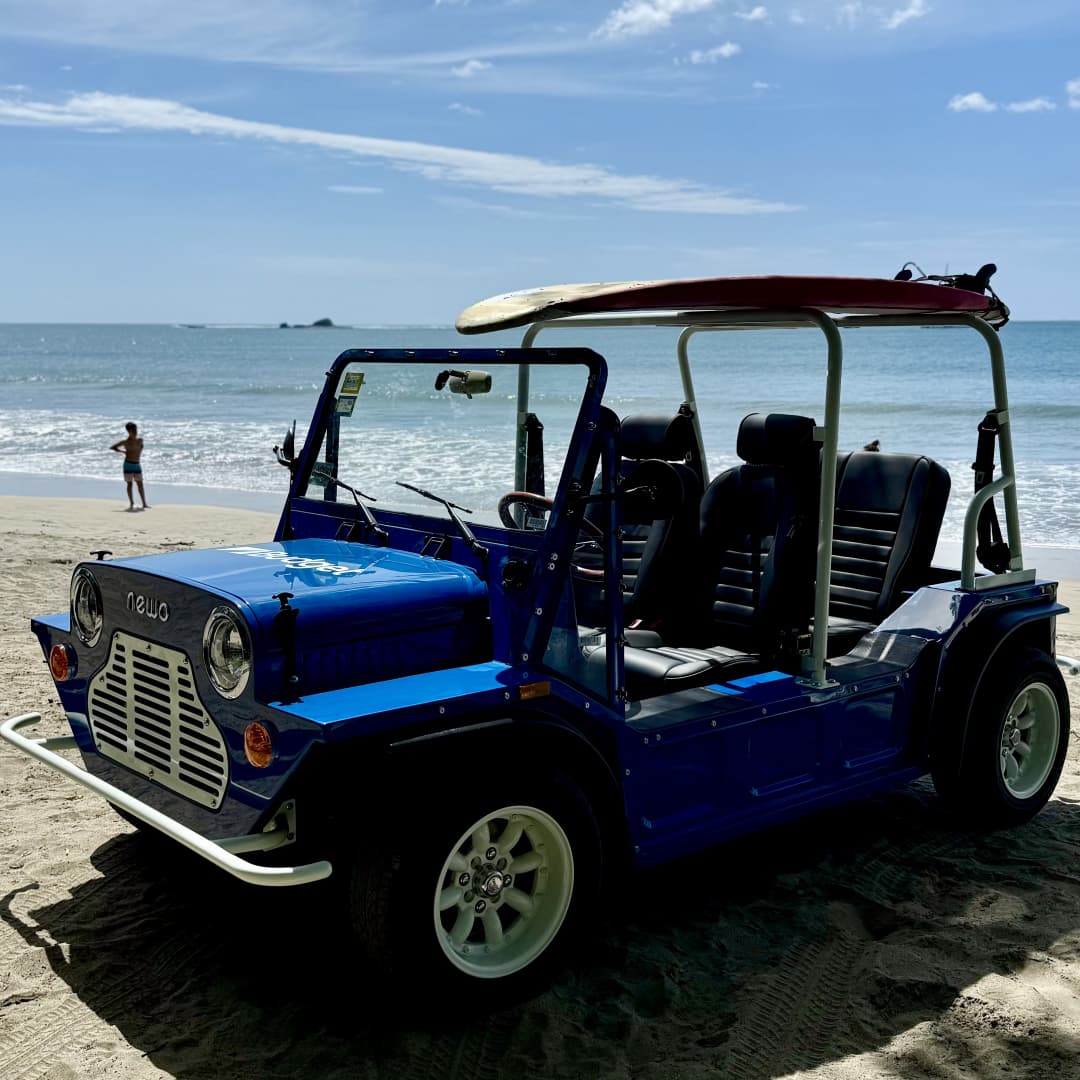 a blue car on the beach